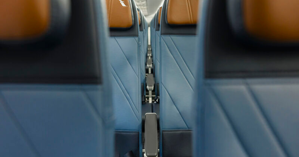 Blue seatbacks and tan headrests viewed along the E175 cabin.
